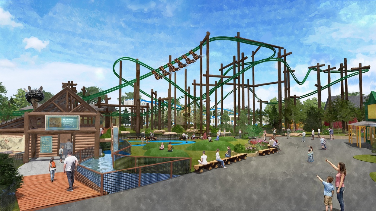 Six Flags Great America with rides, log cabin, and people enjoying the sunny day.