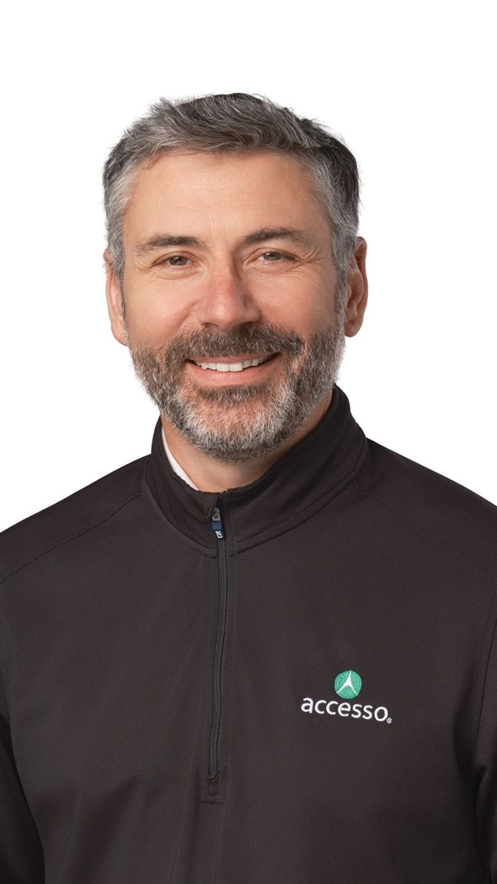 Smiling man named Lee Cowie in a black "accesso" jacket against a white background.