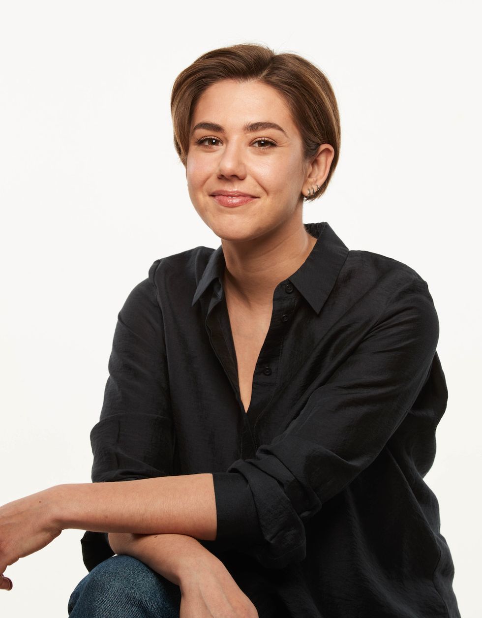 Smiling person in a black shirt with short hair against a plain white background, TAIT creative director Jeanne Me\u0301nard-LeBlanc