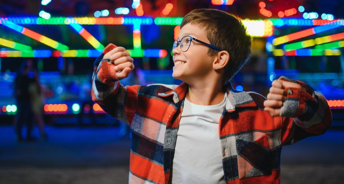 Smiling-young-boy-at-amusement-park