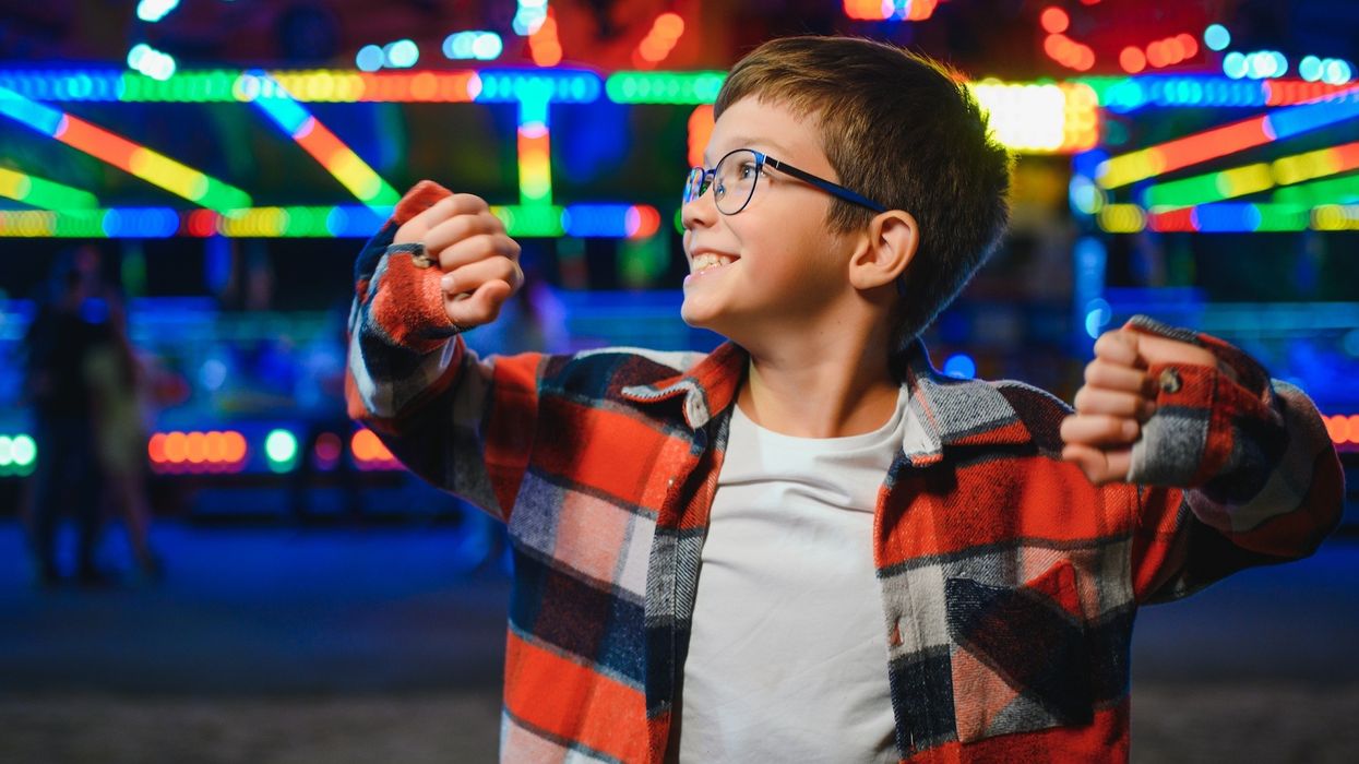 Smiling-young-boy-at-amusement-park
