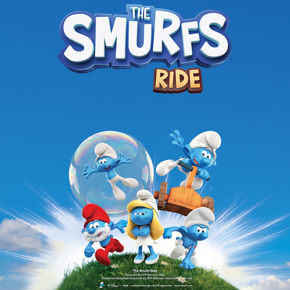 Smurfs having fun on a grassy hill with "The Smurfs Ride" title against a clear blue sky.