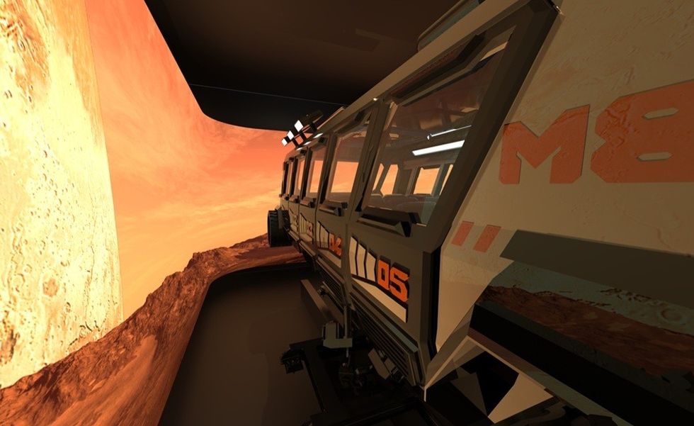 Space-themed ride vehicle against an orange, rocky landscape backdrop.