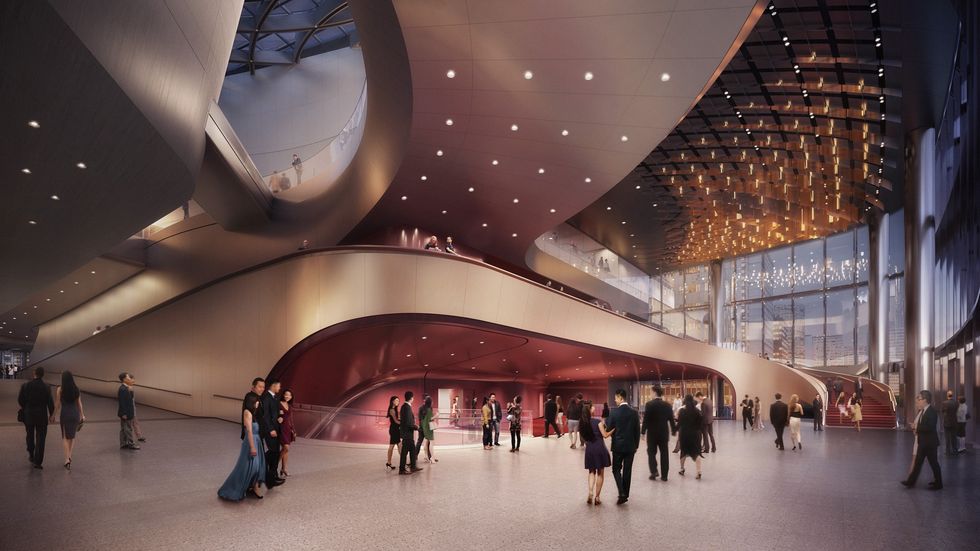 Spacious, elegant lobby of the WestK Performing Arts Centre with people mingling under modern architecture and soft lighting.