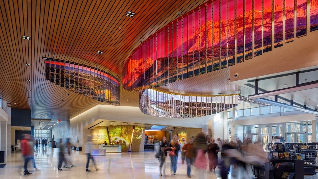 Spacious lobby at Montana Heritage Center with vibrant ceiling art and blurred people walking.