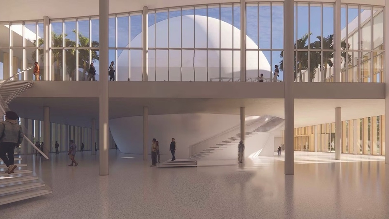 Spacious modern atrium with large windows, stairs, a central dome, and people walking around.