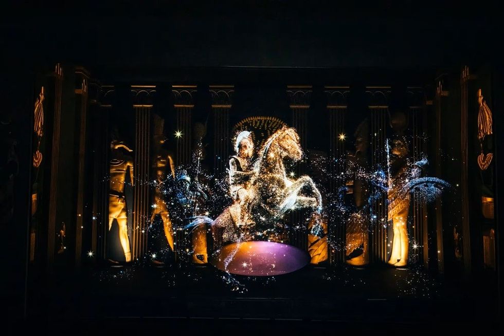 Sparkling holographic horse and rider in a dark, ornate setting with columns.