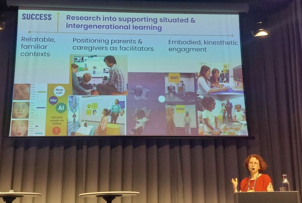 Speaker presenting research on intergenerational learning with visual aids.