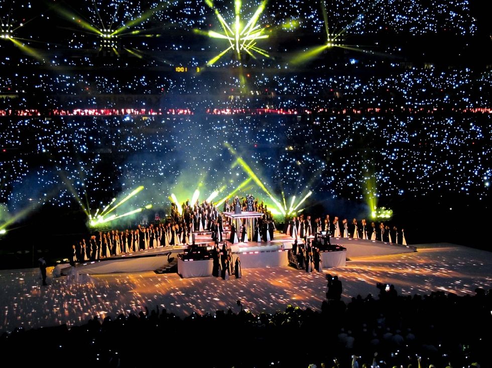 Spectacular stadium concert with bright lights and dancers on stage at the Super Bowl XLVI Halftime Show, Indianapolis 2012