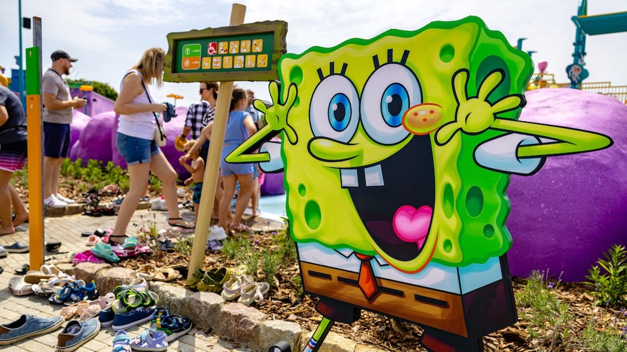 SpongeBob cutout at a Majaland Gdansk, people and shoes scattered around on a sunny day.
