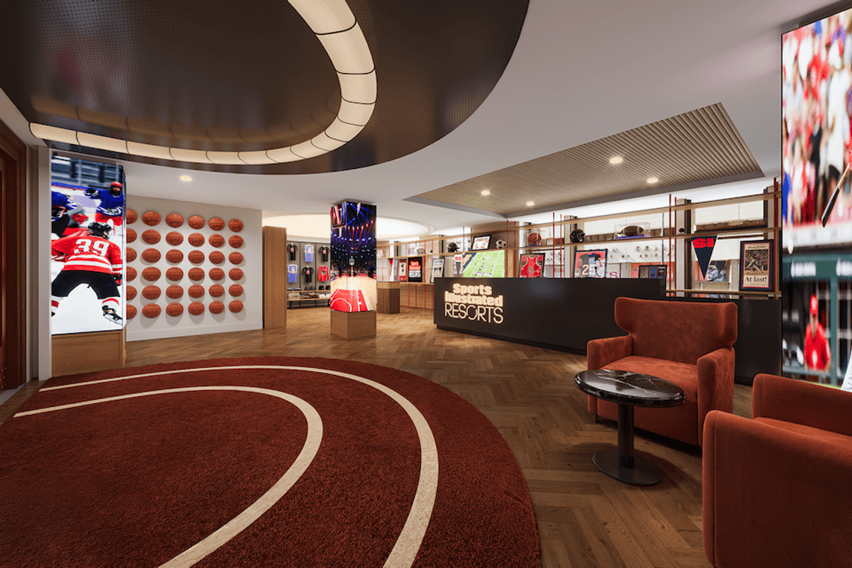 Sports-themed lobby with basketball wall, digital displays, and red seating area.