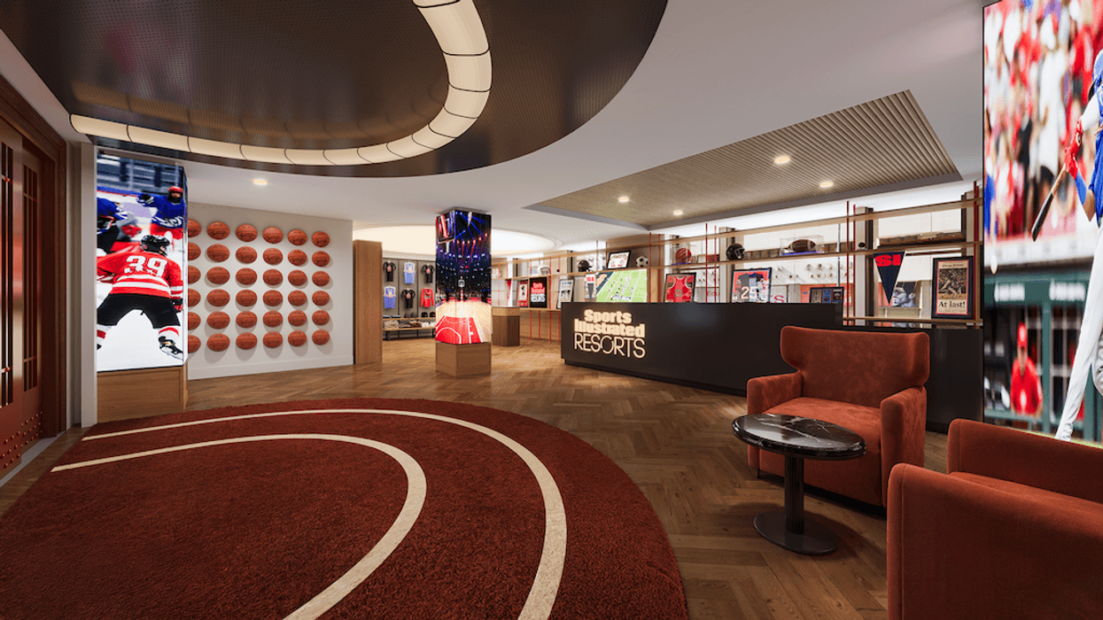 Sports-themed lobby with basketball wall, digital displays, and red seating area.
