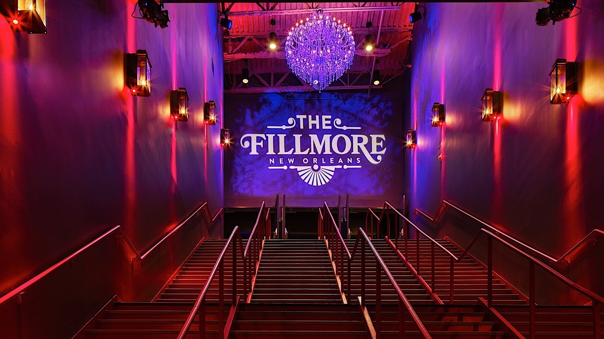 Staircase leading to The Fillmore New Orleans, lit by a chandelier and wall lights.