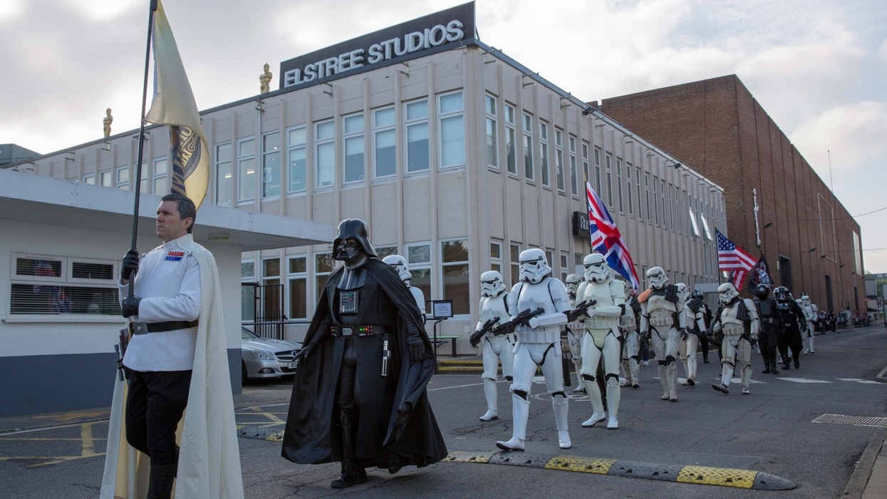 Star Wars characters marching at Elstree Studios with flags and stormtroopers.