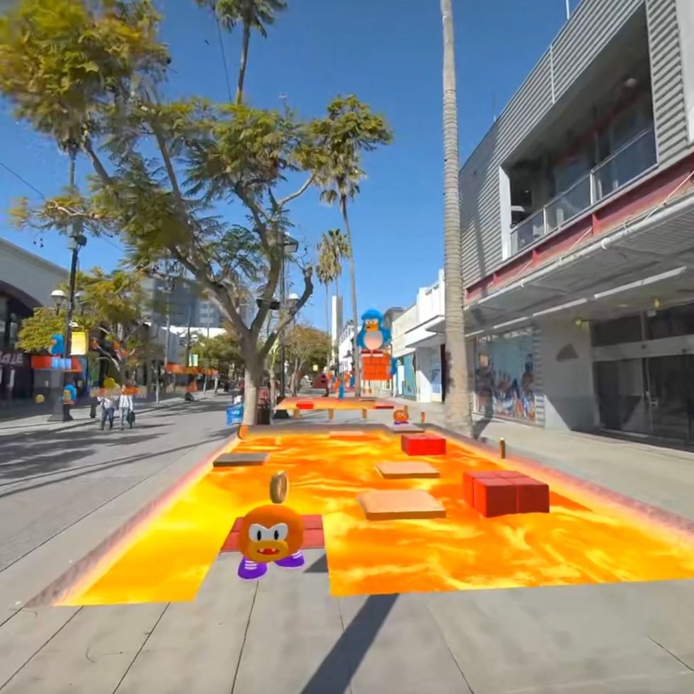 Street with virtual lava and cartoon obstacles overlaid on the sidewalk.