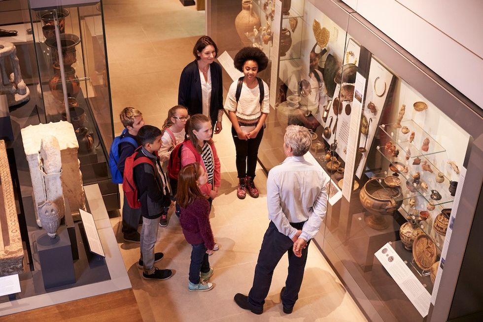 Students Looking At Artifacts In Case On Trip To Museum creating the visitor experience