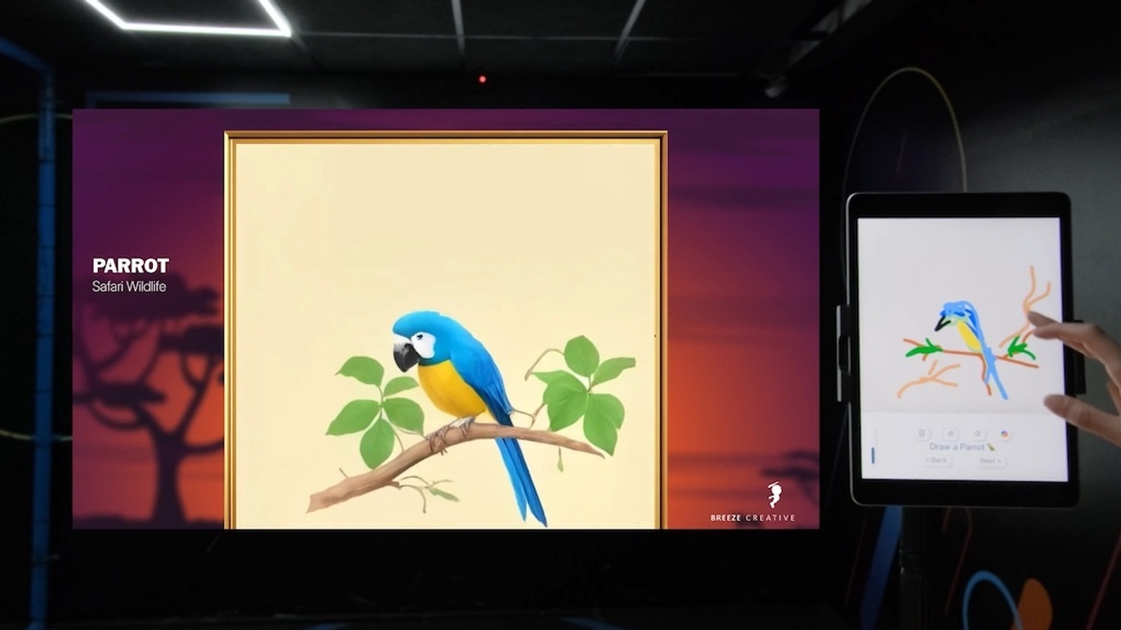 Tablet drawing of a parrot with an AI version displayed on a large screen in a dark room, Magic Painter from Breeze Creative