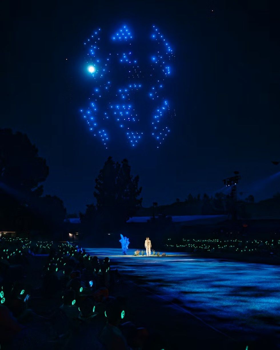 The Cort\u00e8ge: A Festive Funeral for Our Times drones over head of a performer