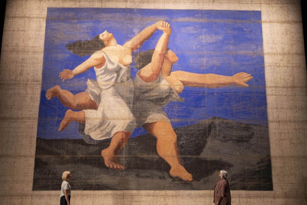 The largest Picasso work in the world, the 1924 front stage cloth for the Ballets Russes’ production, Le Train Bleu, at V&A East Storehouse. Image by David Parry/PA Media Assignments. Pablo Picasso, Le Train Bleu front stage cloth, 1924 © The estate of Pablo Picasso