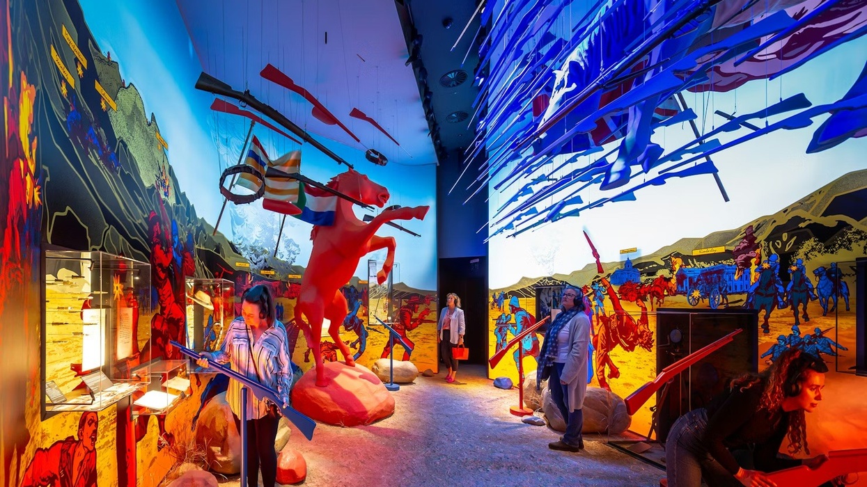 The War Rooms at The Story of Emily. Vibrant interactive exhibit with colorful murals and suspended red and blue elements.