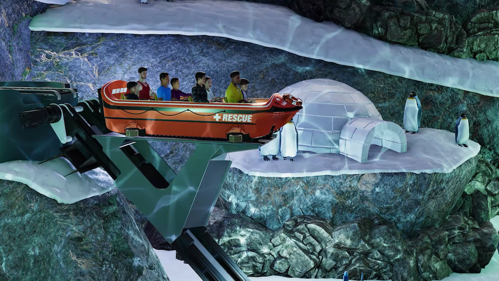 Theme park ride with people in a rescue boat passing penguins and an igloo.