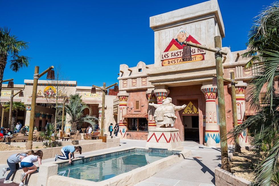 Theme park with Egyptian-style restaurant and playful statues.