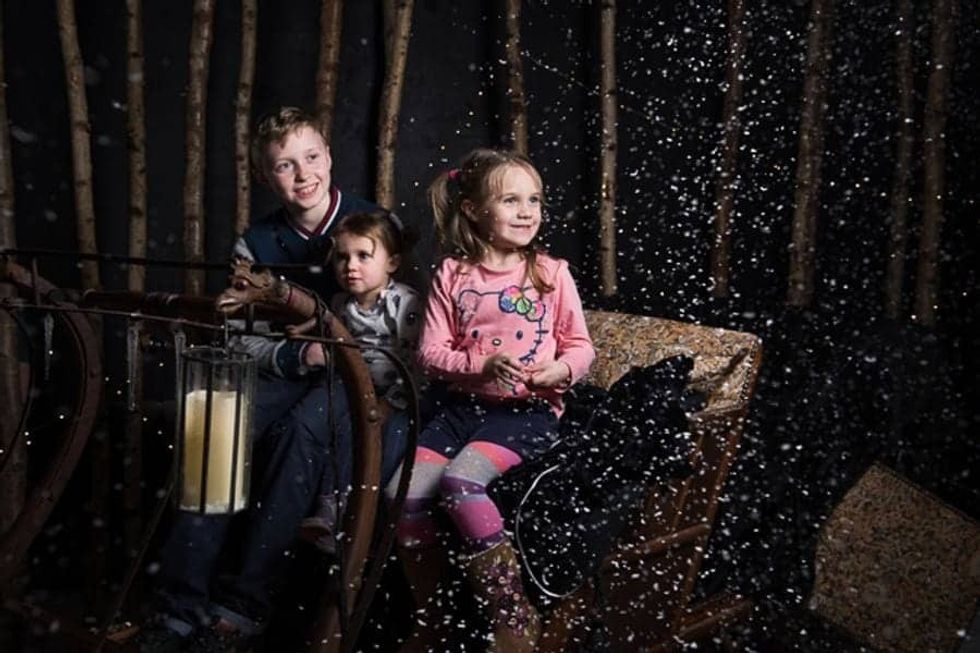 Three children on a carriage in Narnia at The Story Museum