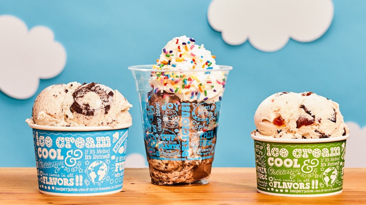 Three ice cream servings in cups against a blue cloudy backdrop.