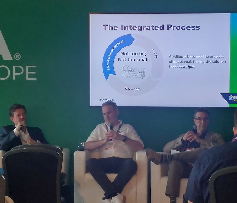 Three men on panel discussing "The Integrated Process" presentation.