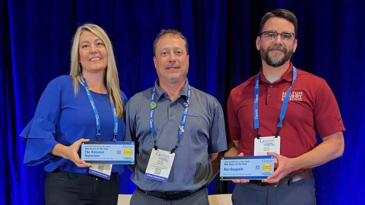 Three people at Gateway Ticketing's North America UGM Customer Excellence Awards 2026 event, two holding plaques, smiling at the camera.