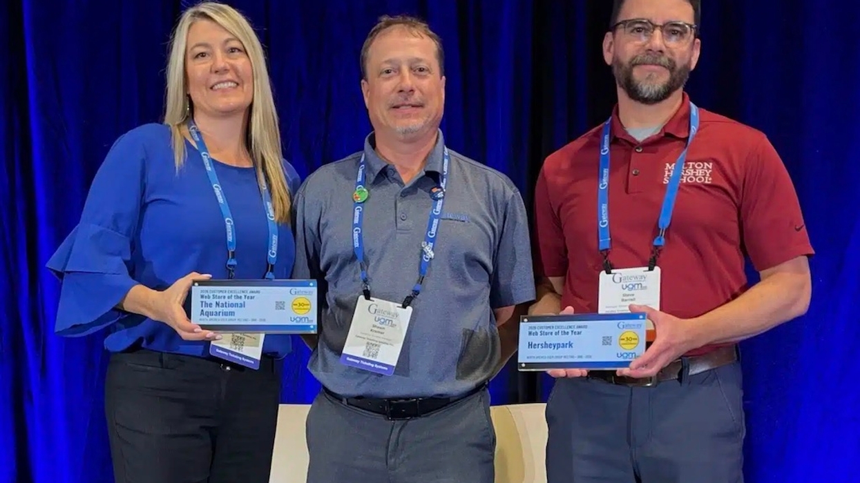 Three people at Gateway Ticketing's North America UGM Customer Excellence Awards 2026 event, two holding plaques, smiling at the camera.