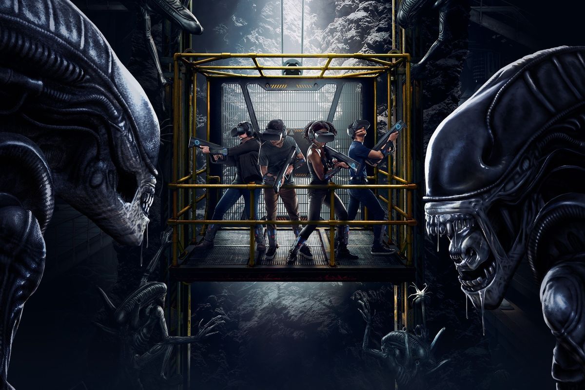 Three people in VR gear, holding guns, surrounded by alien creatures in a dark, industrial setting.