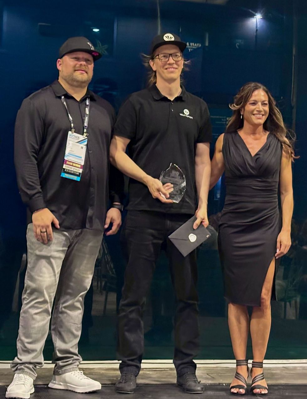 Three people posing on stage; one, named Dr. Raine Kajastila, holding the 2026 IATP Pioneer Award.