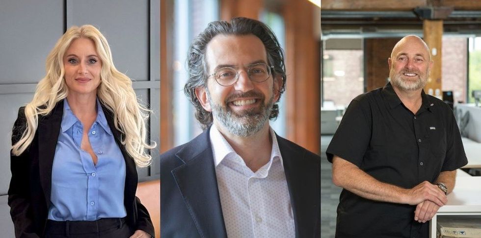 Three people smiling in professional attire in an office setting.