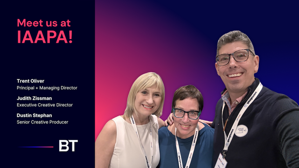 Three smiling people with IAAPA event and BT company details on a colorful background.