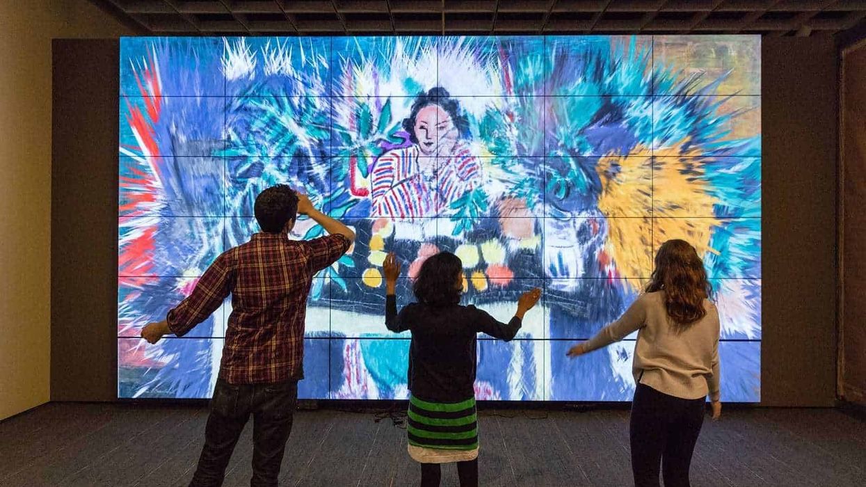 Three visitors interacting with the ArtLens Gallery at The Cleveland Museum of Art