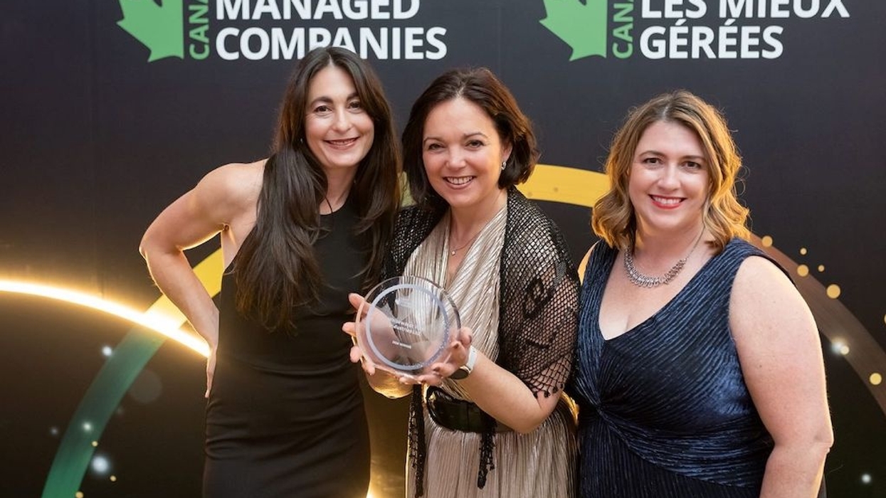 Three WhiteWater team members smiling, holding an award at Canada Best Managed Companies event.