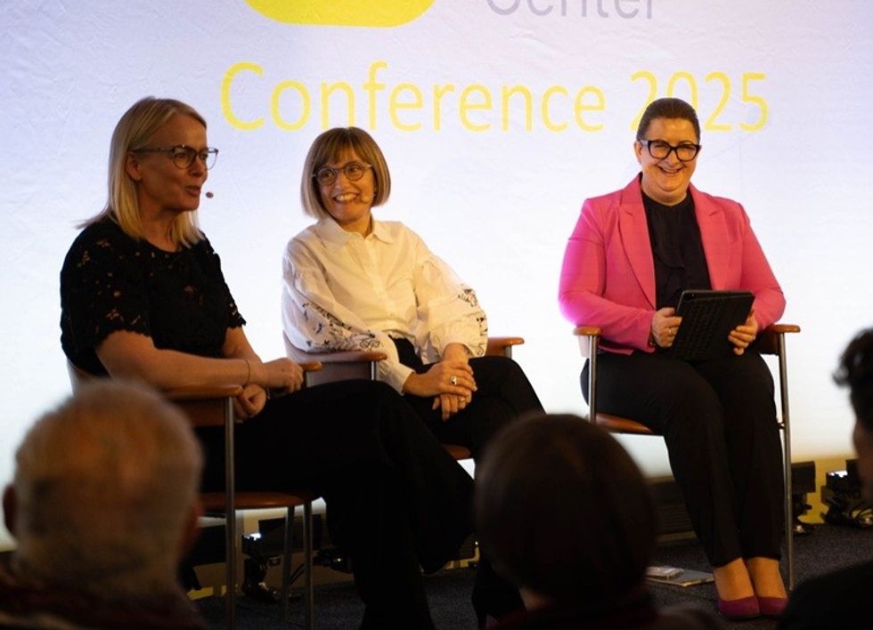 Three women seated, speaking at the 2025 Brand Experience Center Conference.