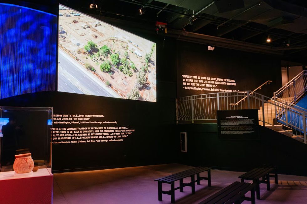 THRIVE \u2014 The First People: Yesterday, Today, and Forever Museum exhibit with large screen, quotes, benches, and pottery display.