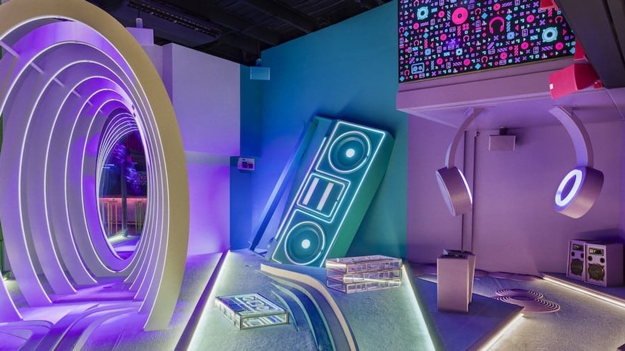 Tight view of BOXPARK Wembley Pop Golf mini course lit with rainbow lights