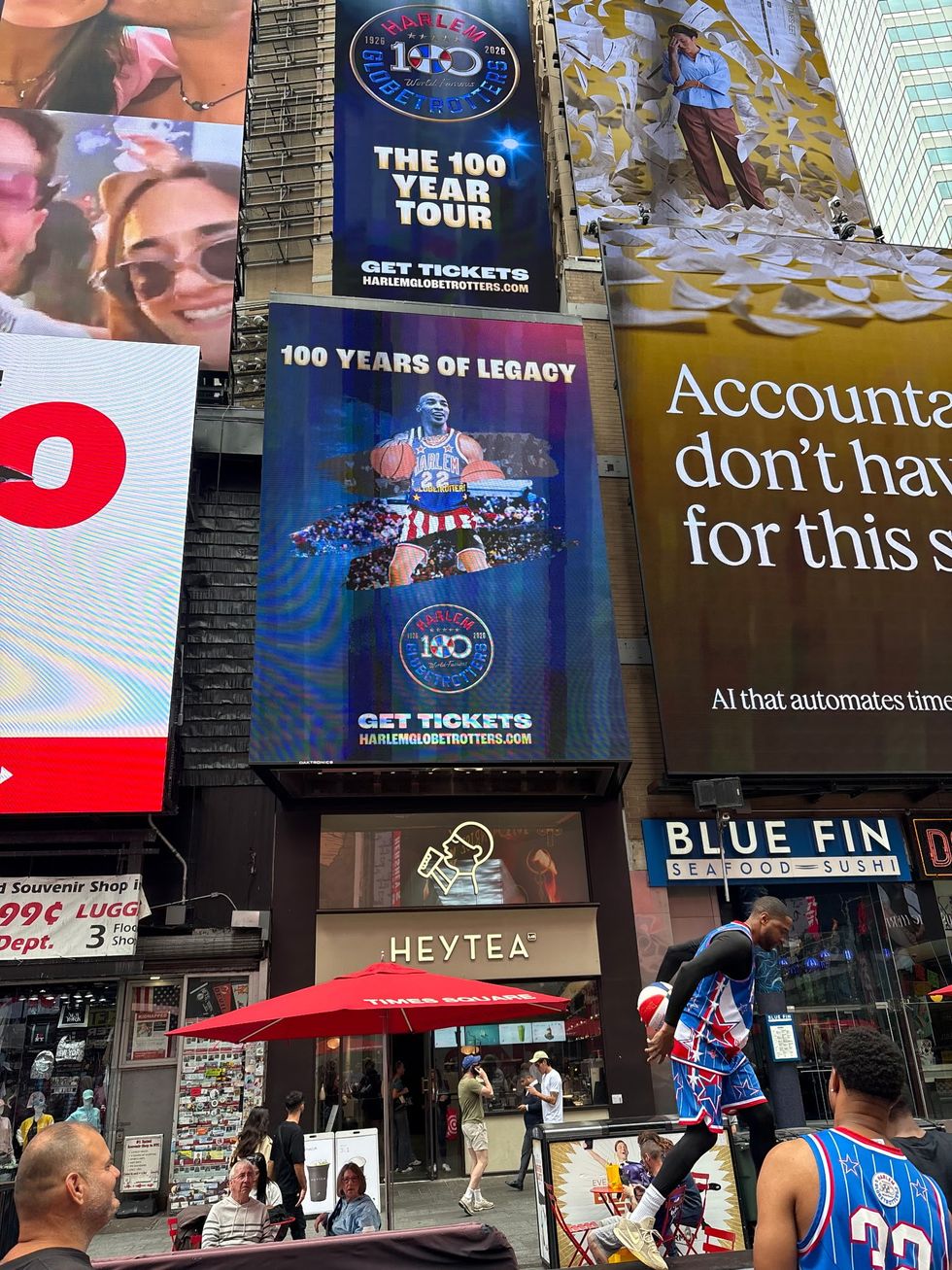 Times Square billboards promoting Harlem Globetrotters' 100th-anniversary tour.