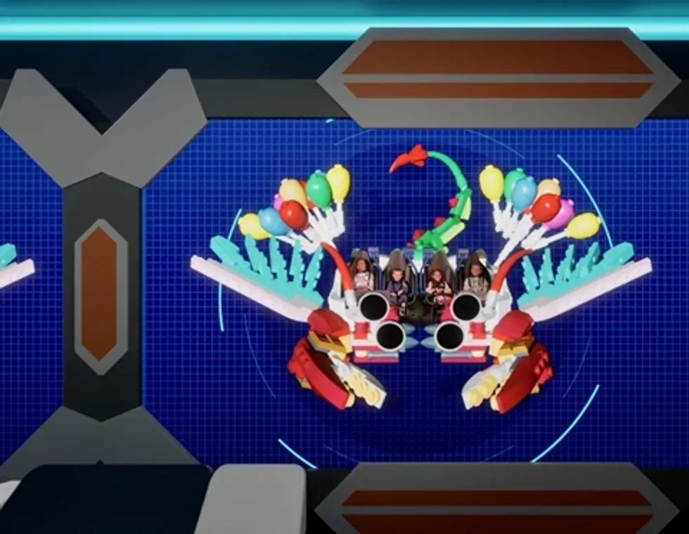 Toy robot crab with kids inside, decorated with balloons and wings on a grid background.