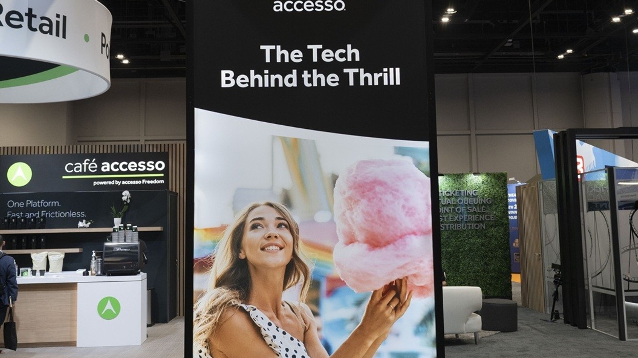 Trade show booth with a display of smiling woman holding cotton candy.