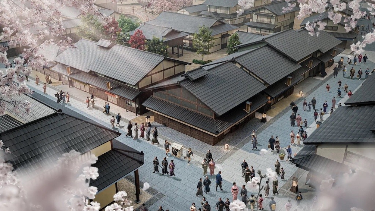 Traditional Japanese village scene with people, surrounded by cherry blossoms.