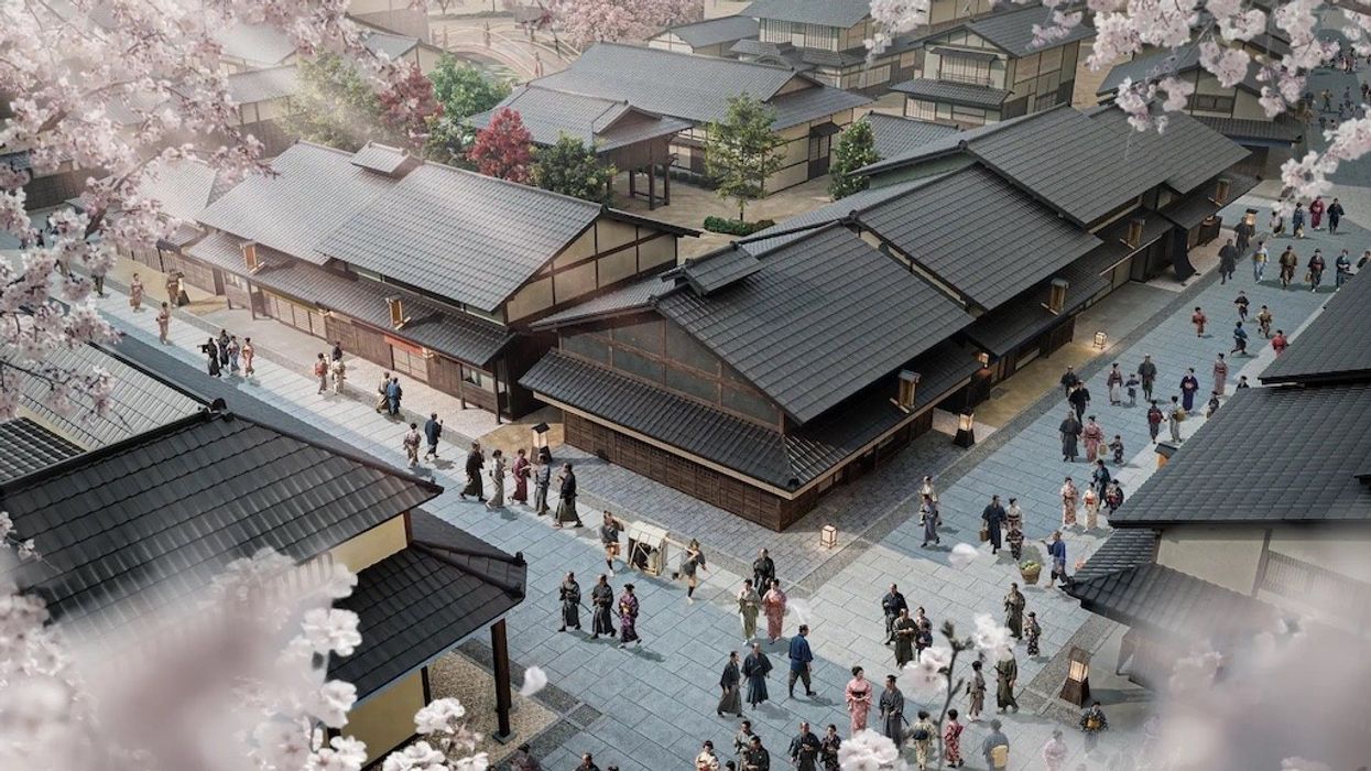 Traditional Japanese village scene with people, surrounded by cherry blossoms.
