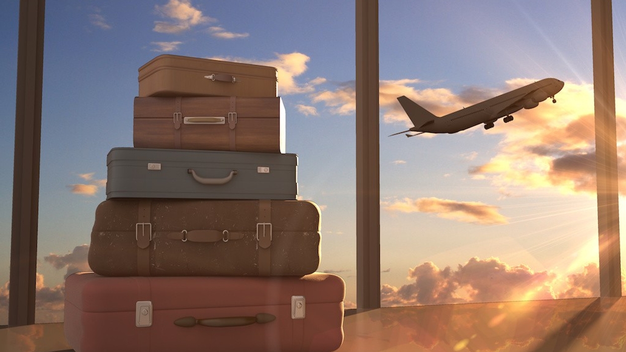 travel bags and airplane in sky