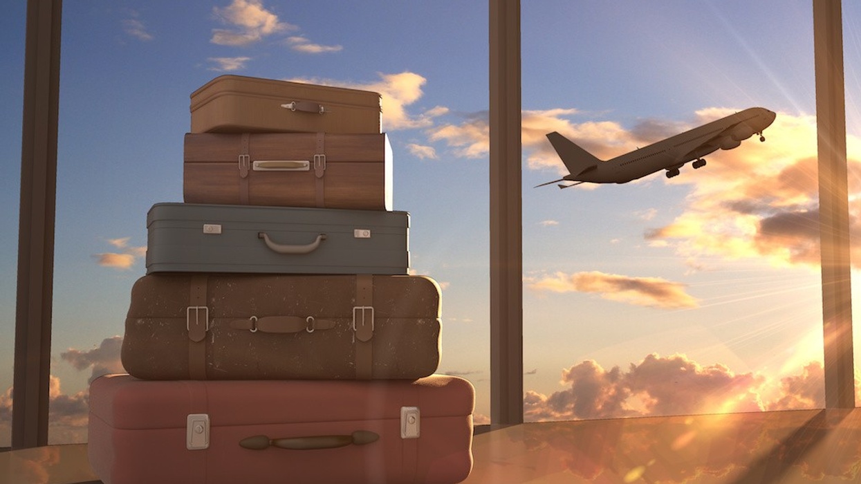 travel bags and airplane in sky