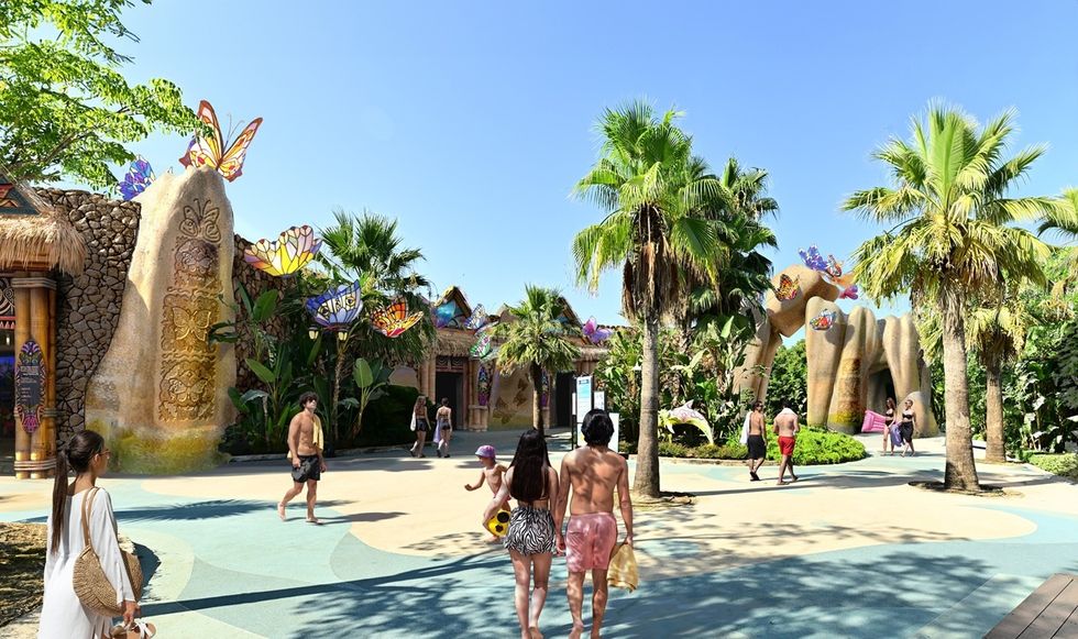 Tropical-themed park with butterfly decorations, palm trees, and visitors strolling.