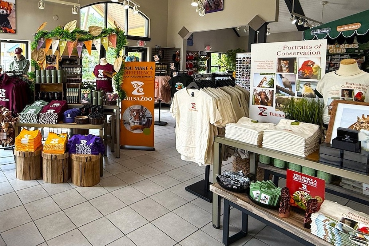 Tulsa Zoo gift shop with shirts, plush toys, and conservation displays.
