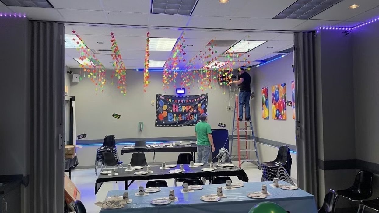 TwinkleTwinkleStar Room decorated for a birthday party with people hanging star streamers.